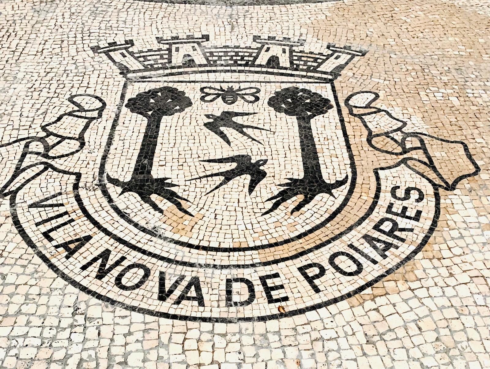The town crest, laid in traditional calçada mosaic