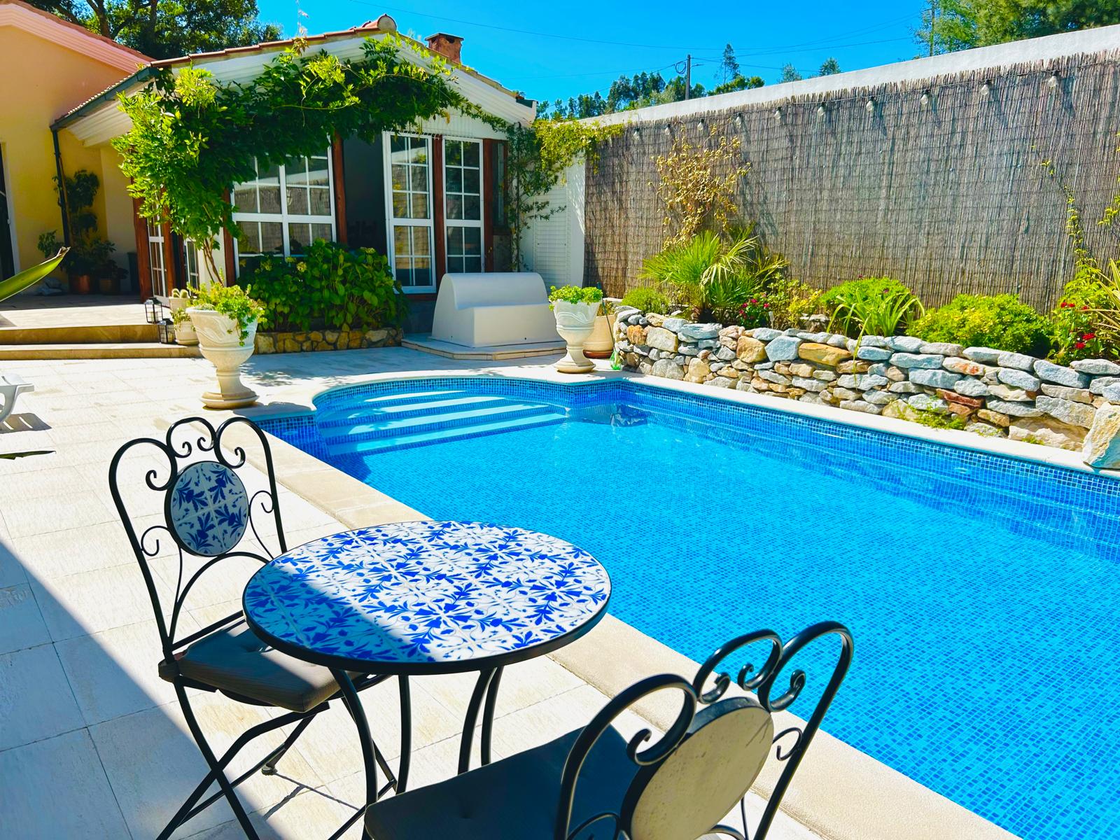 Poolside bistro table with Portuguese tile top overlooking the water