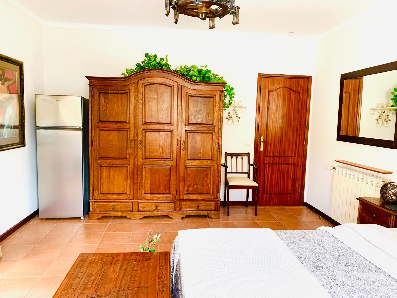 Handcrafted oak armoire beside the door in the Rose Parlor